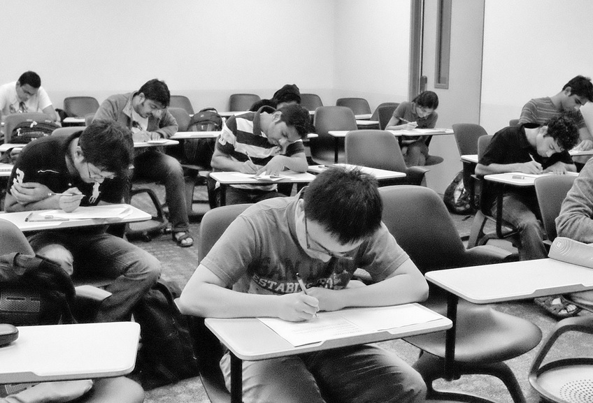 Students at desks taking exams