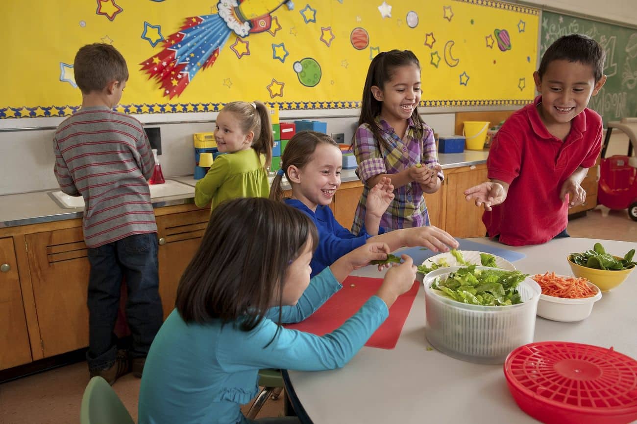 Schoolchildren making a salad together