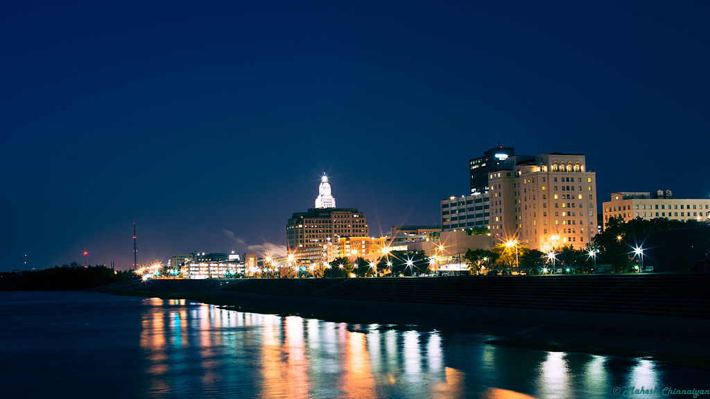 Image of skyline of Baton Rouge from the river and taken at night so the buildings are glistening.