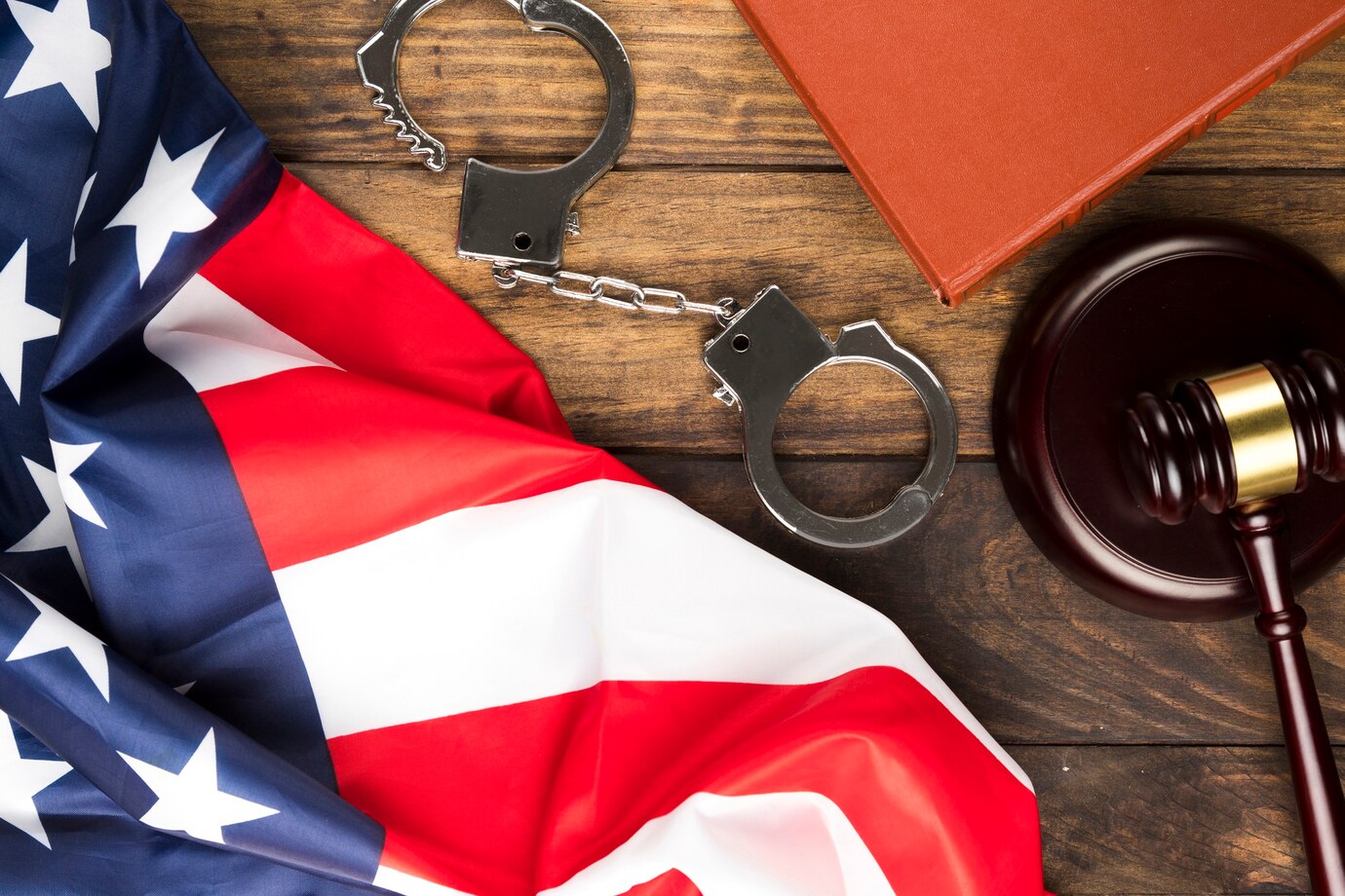 American flag, gavel and block and a pair of handcuffs