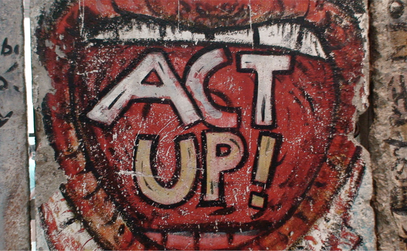 Graffiti from the Berlin Wall (modified), now housed in the Newseum in Washington, DC names the ACT UP organization.