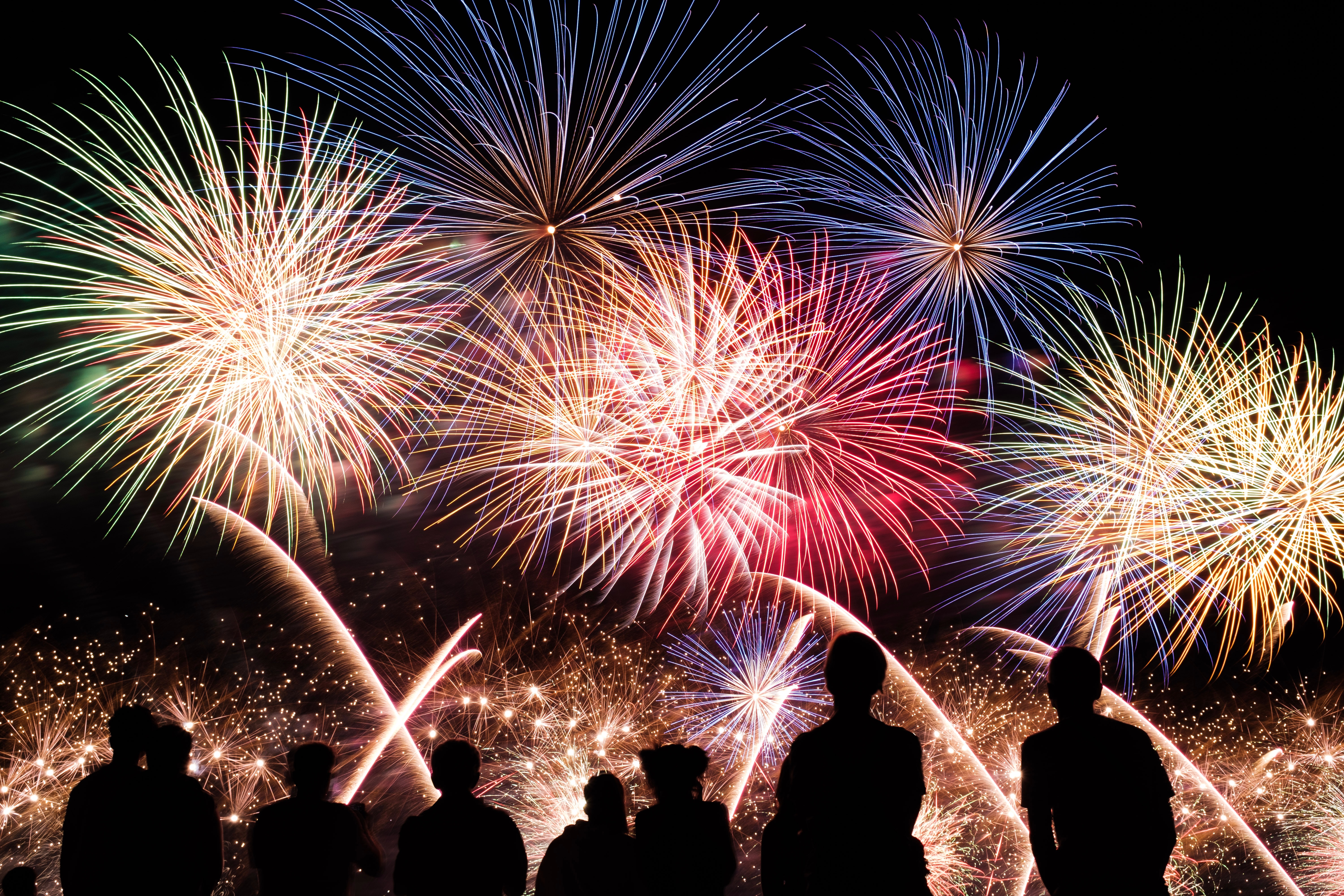 Fireworks with people in silhouette. 