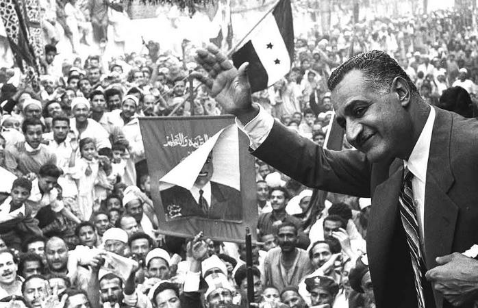 Egyptian President Gamal Abdel Nasser waving to crowds in Mansoura from a train car. 